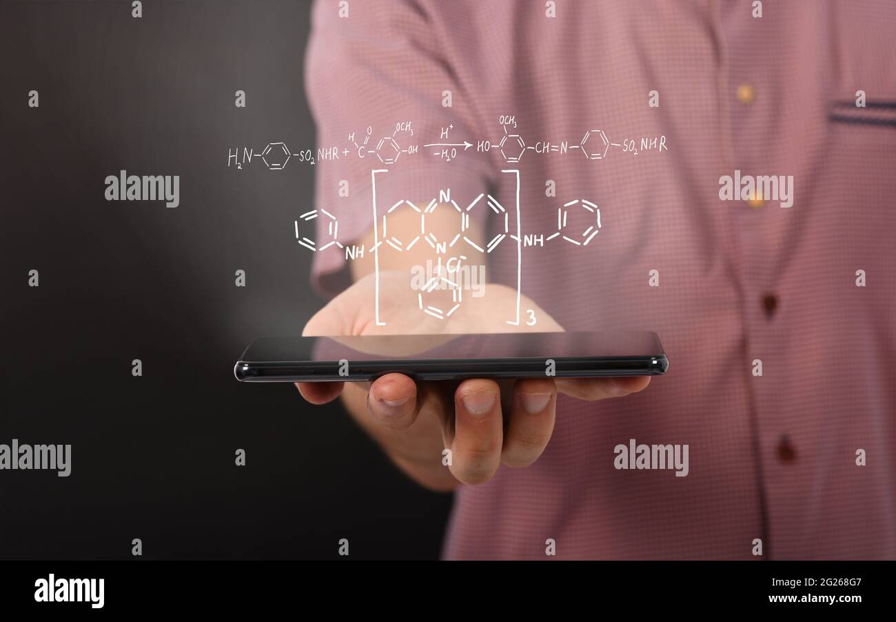 Hand hält den schwarzen Tablet-Computer horizontal mit einem Reaktionsdiagramm organischer chemischer Verbindungen. Isoliert auf schwarzem Hintergrund. Hohe Resoluti Stockfoto