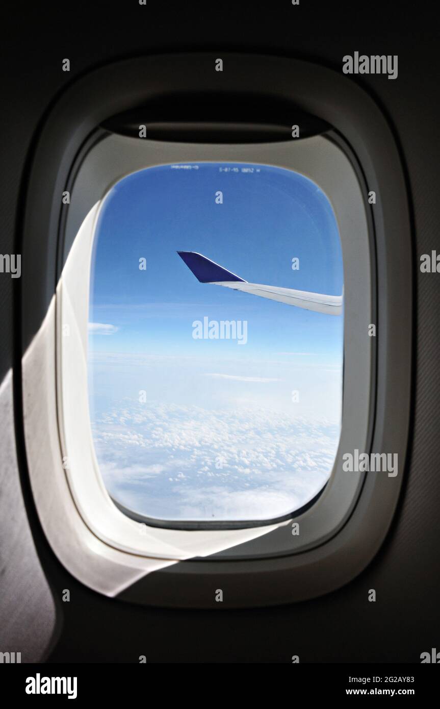 Blick auf den blauen Himmel vom Fenster des Flugzeugs Stockfoto