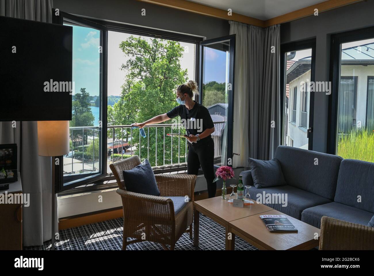 Bad Saarow, Deutschland. Juni 2021. Sabine Sauer, Haushälterin des Hotel  Esplanade Resort and Spa, reinigt ein Geländer an einem Fenster eines  Hotelzimmers. Ab dem 11. Juni sind wieder private Übernachtungen in Hotels
