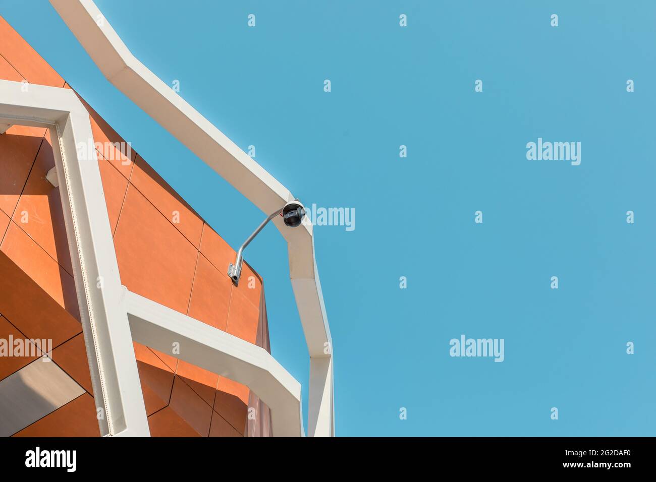 Runder CCTV-Außenkamera auf dem Dach des blauen Himmels im Hintergrund des Gebäudes. Stockfoto
