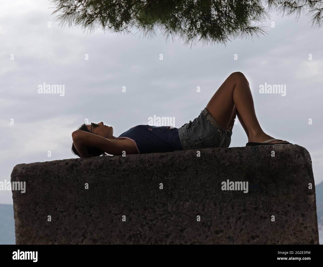 Silhouette der weiblichen Verlegung auf Stein und entspannend. Stockfoto