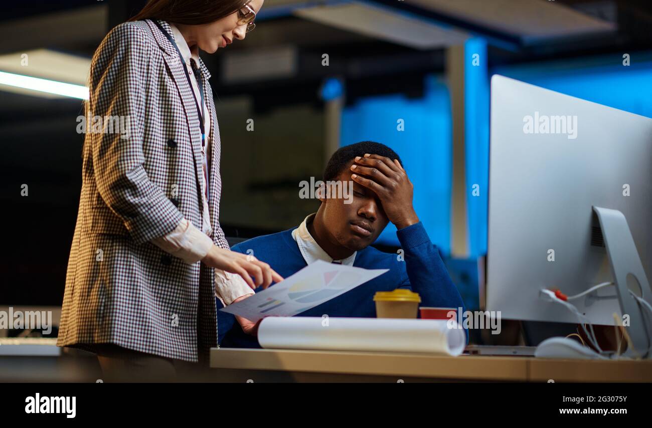 Müde Manager arbeiten im Nachtbüro Stockfoto