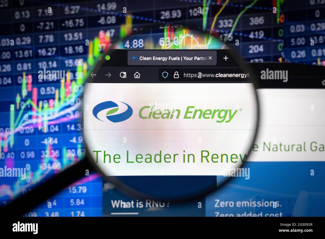 Clean Energy fuels Firmenlogo auf einer Website mit verschwommenen Börsenentwicklungen im Hintergrund, die auf einem Computerbildschirm zu sehen sind Stockfoto