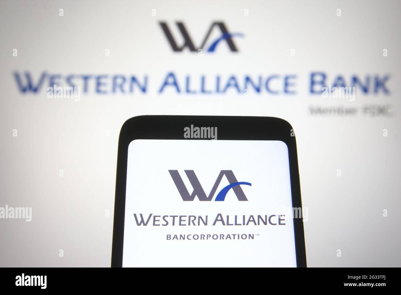 In dieser Fotolabbildung ist ein Western Alliance Bancorporation Logo auf einem Smartphone-Bildschirm mit einem Western Alliance Bank Logo im Hintergrund zu sehen. Stockfoto