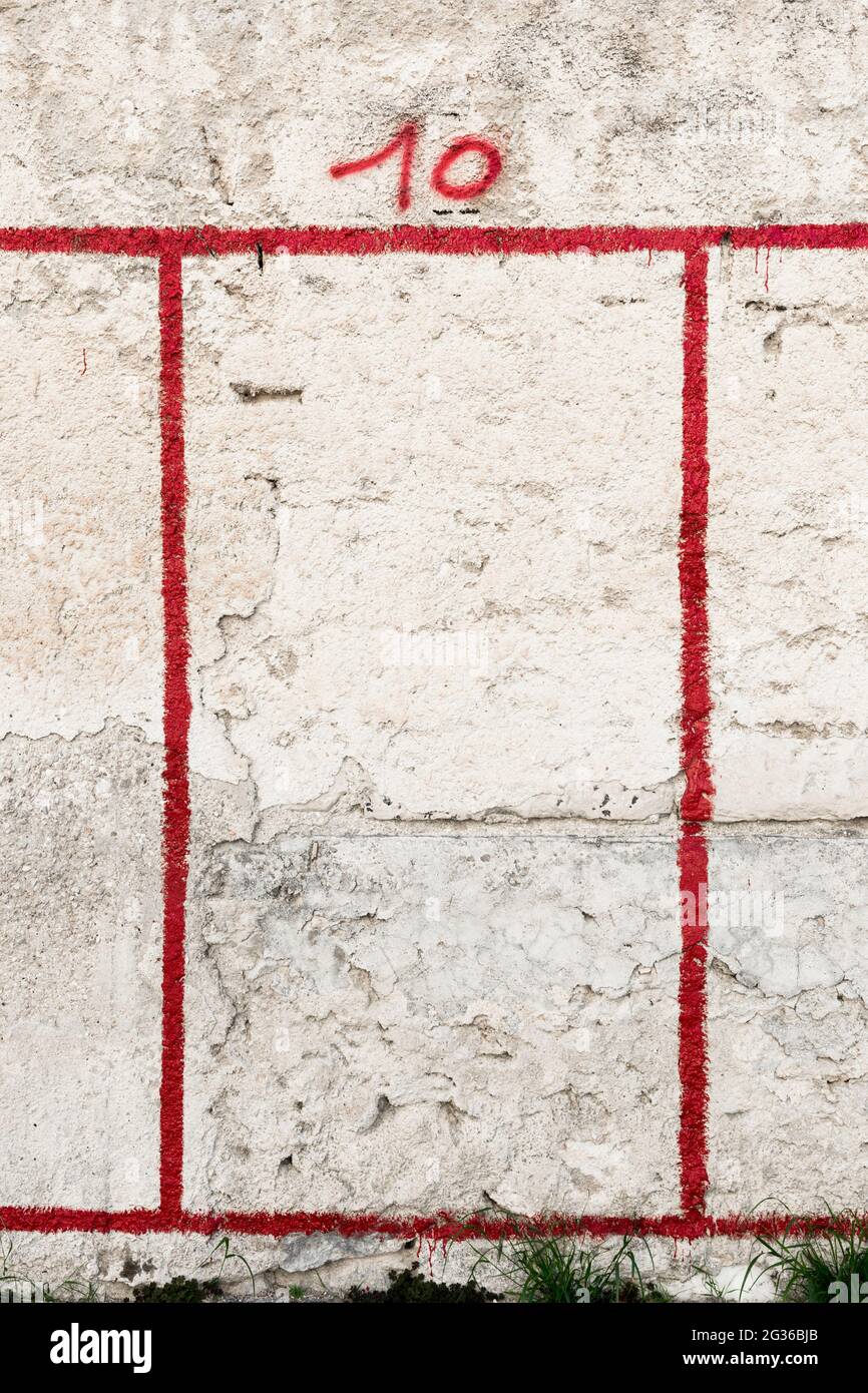 Rote Zahl 10 und roter Rahmen auf verwitterte Wand gesprüht Stockfoto