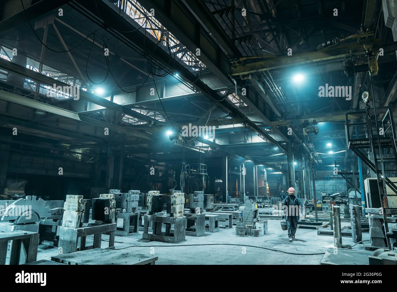 Metallurgische Fabrik, unkenntliche Arbeiterin Maske und Helm, Schwerindustrie. Stockfoto