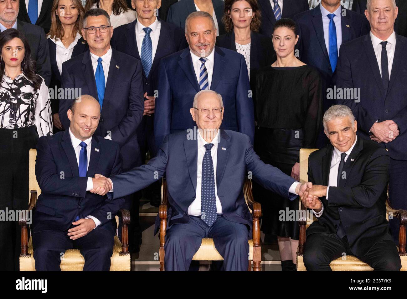 (210614) -- JERUSALEM, 14. Juni 2021 (Xinhua) -- Der neue israelische Premierminister Naftali Bennett (L, erste Reihe), der israelische Präsident Reuven Rivlin (C, erste Reihe) und der alternative Premierminister und Außenminister Yair Lapid (R, erste Reihe) posieren für ein Gruppenfoto mit den neuen Regierungsministern in der Residenz des Präsidenten in Jerusalem, 14. Juni 2021. (JINI via Xinhua) Stockfoto