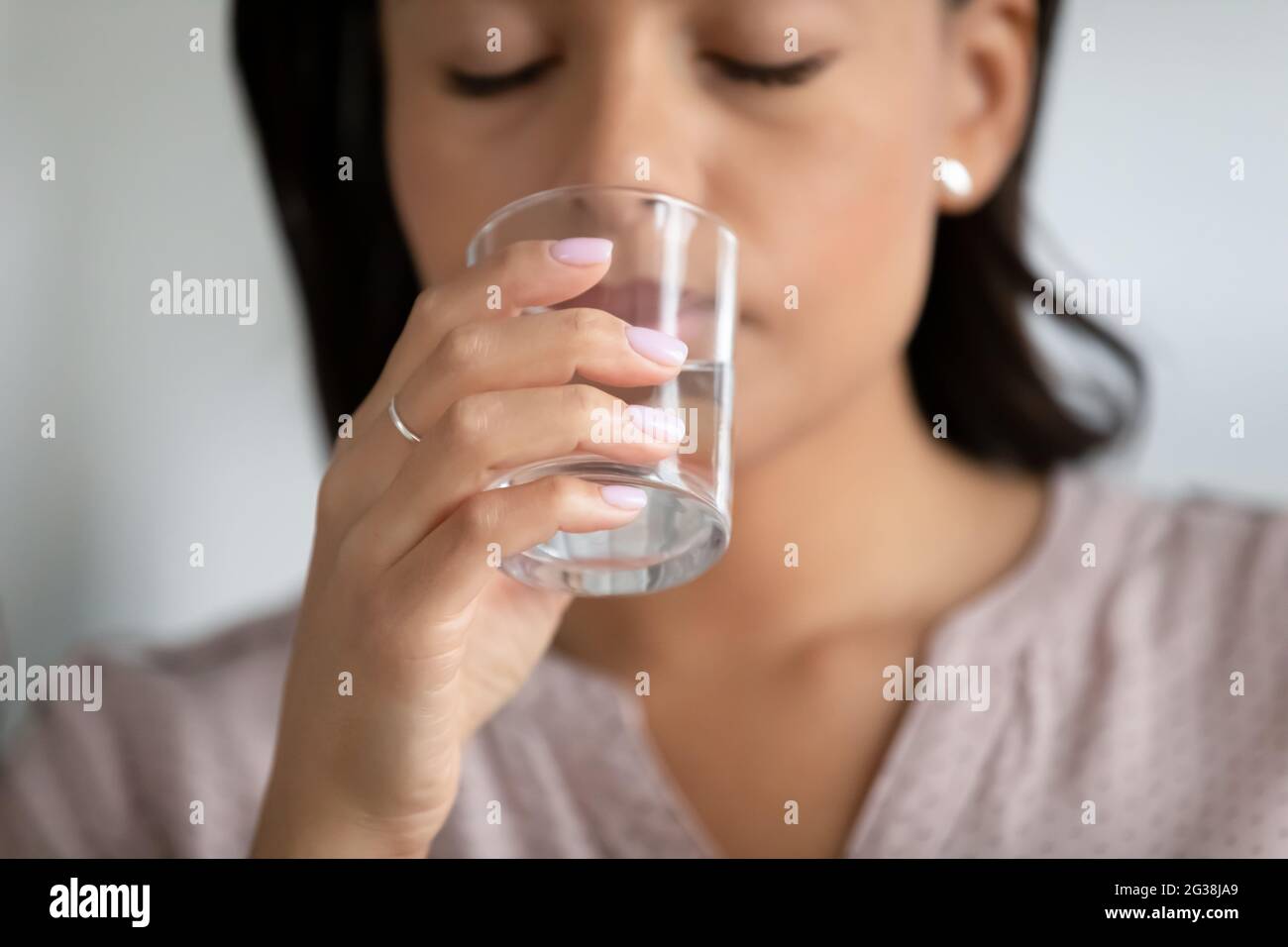 Hand einer Frau mit transparentem Glas aus reinem Wasser Stockfoto