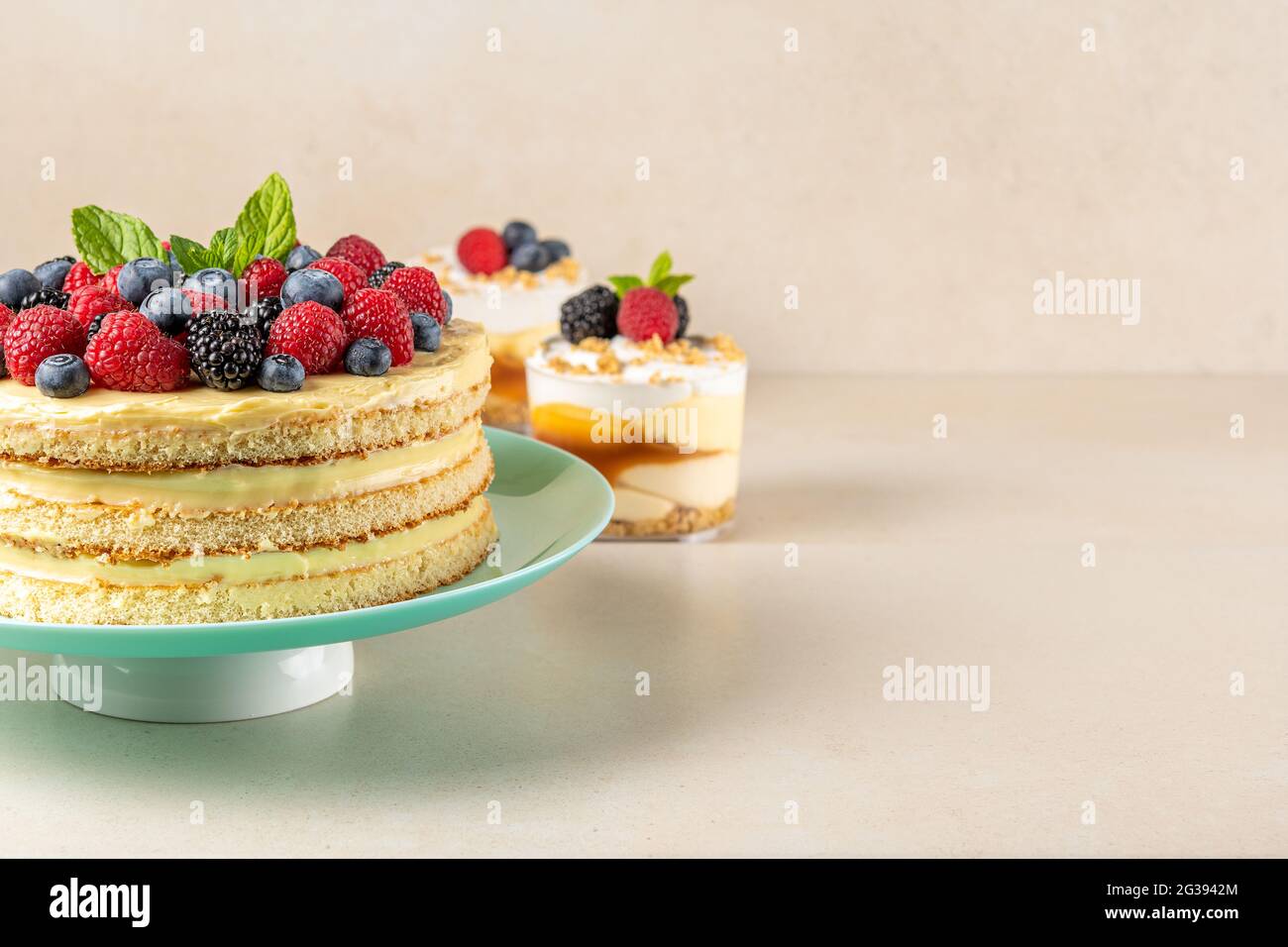 Hausgemachter Kuchen mit frischen Beeren und süßen Desserts auf dem Tisch. Stockfoto