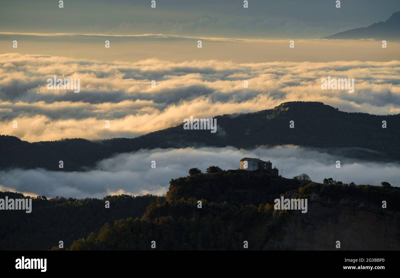 La Quar Sanctuary vor einem Nebelmeer bis nach Montseny. Vom Gipfel Salga Aguda aus gesehen, in der Serra de Picancel, bei Sonnenaufgang (Katalonien, Spanien) Stockfoto