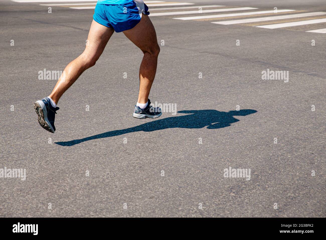 Beine Läufer laufen auf grauem Asphalt Marathon Stockfoto
