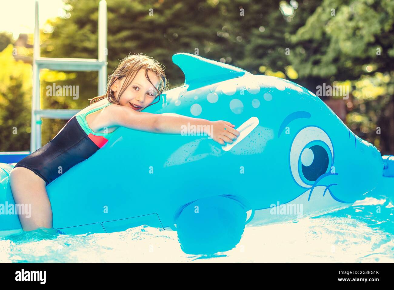 Kleines Madchen Mit Aufblasbarem Wal Spielt In Einem Schwimmbad Stockfotografie Alamy