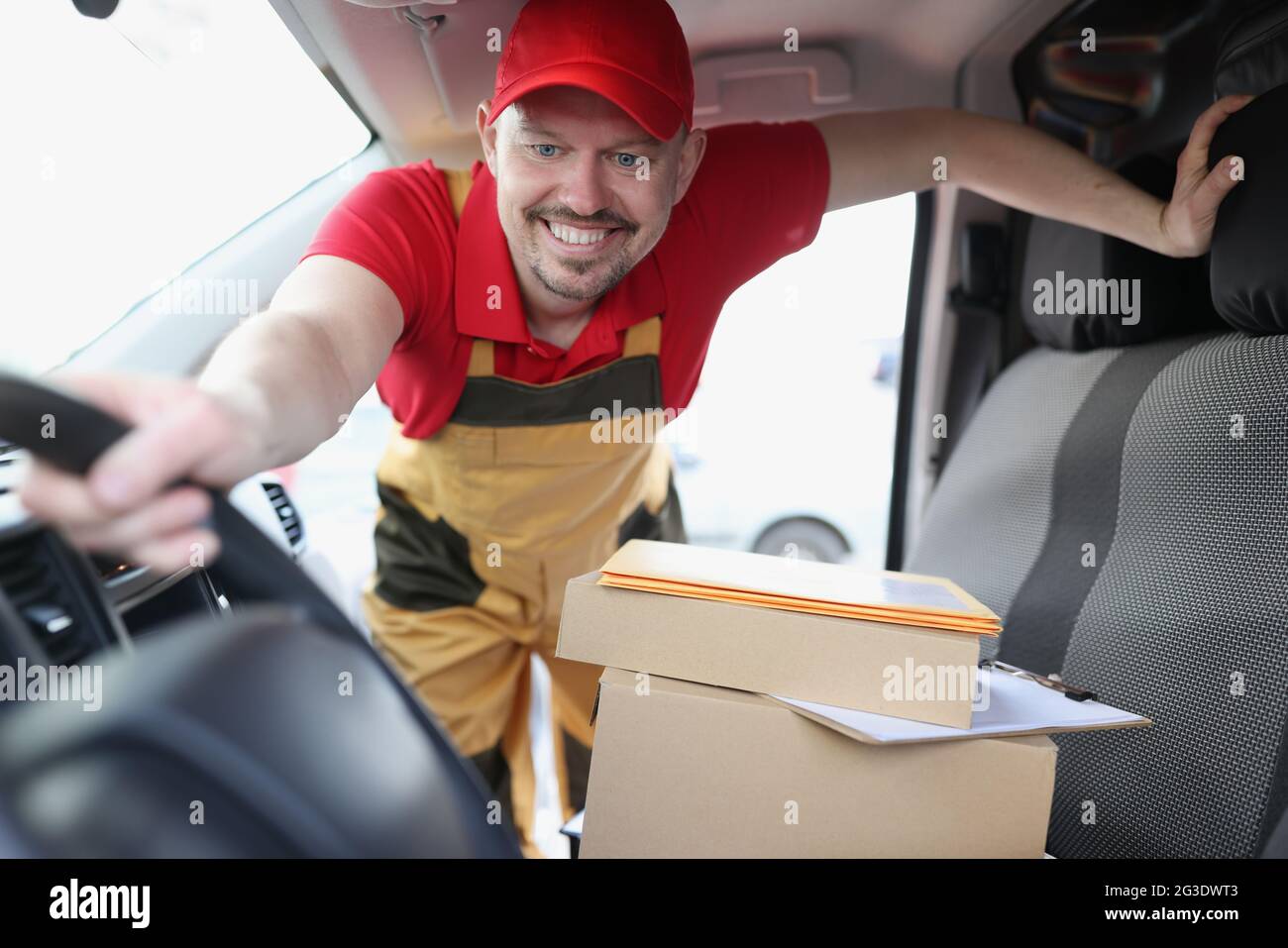 Kurierfahrer holt Kartons im Auto ab Stockfoto