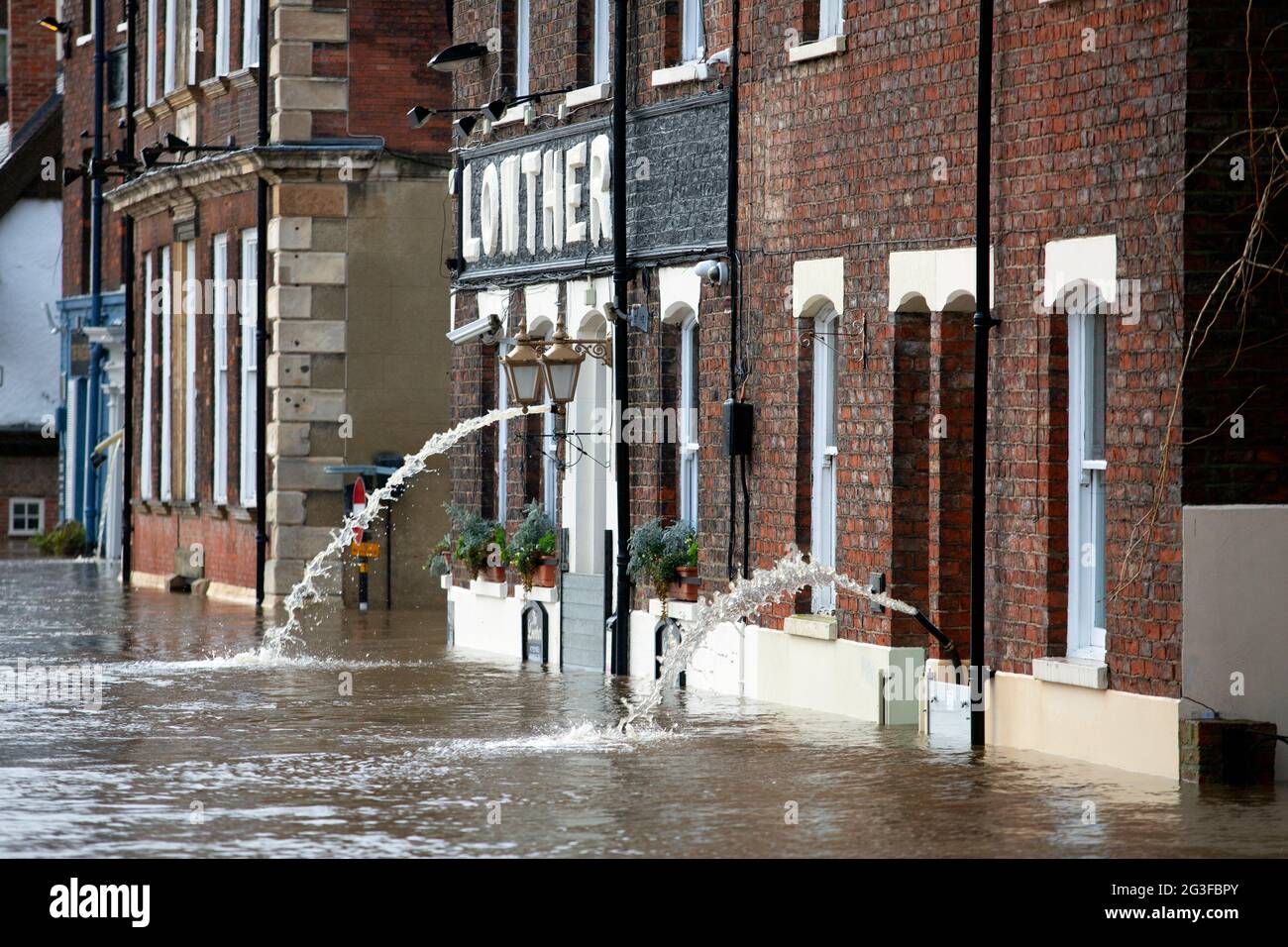 Das Wasser wird aus überfluteten Ufergrundstücken in York, Nord-Yorkshire, gepumpt, da der Wasserstand auf dem Fluss Ouse während des Sturms C dramatisch ansteigt Stockfoto
