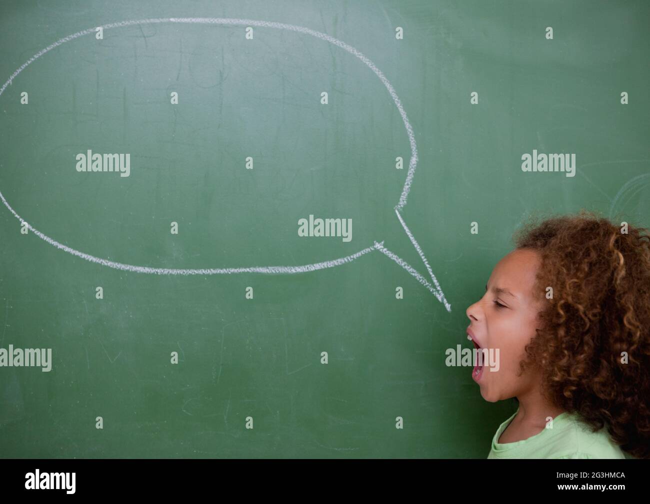 Komposition von Mädchen schreiend mit leerer Kreide Rede Blase kopieren Raum auf Kreidetafel Stockfoto