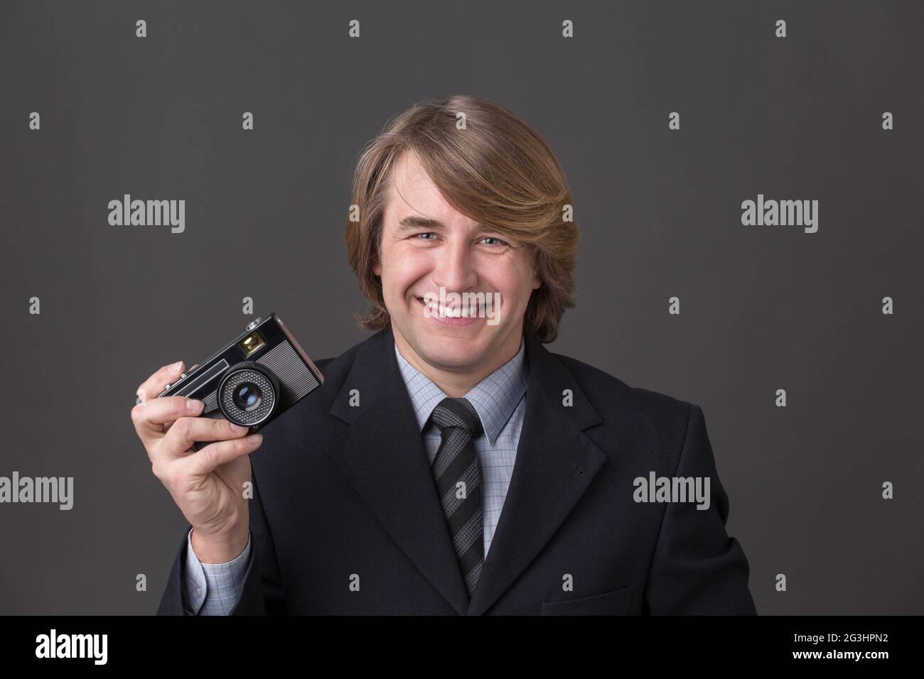 Geschäftsmann mit Fotokamera Stockfoto