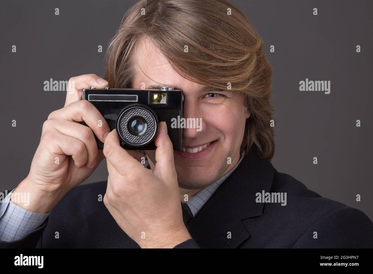 Geschäftsmann mit Fotokamera Stockfoto