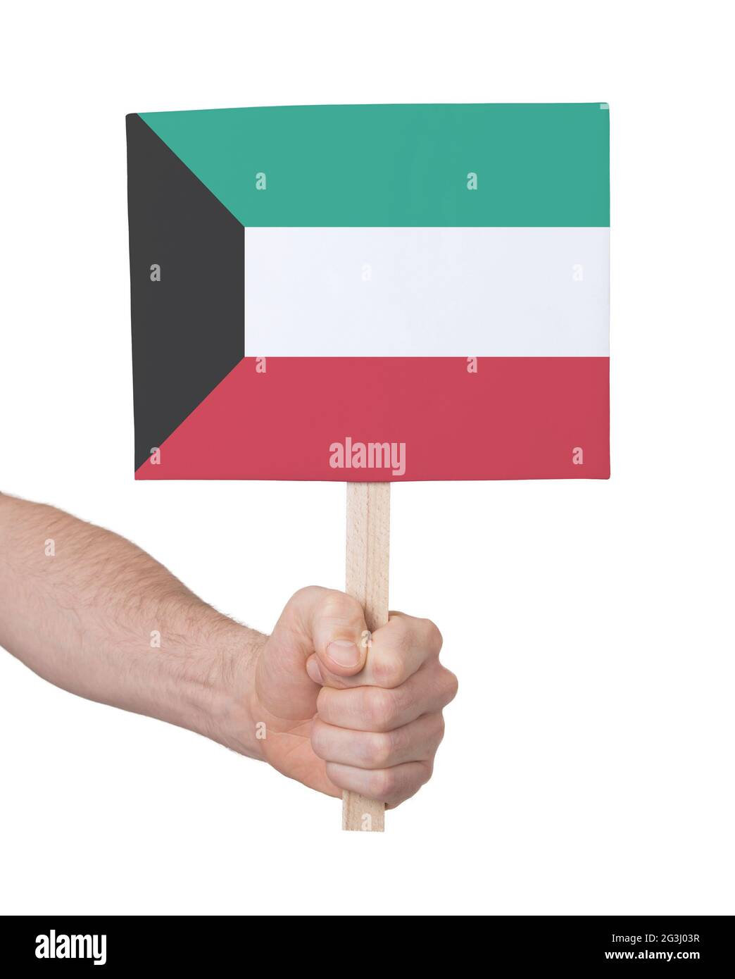 Hand hält kleine Karte - Flagge von Kuwait Stockfoto