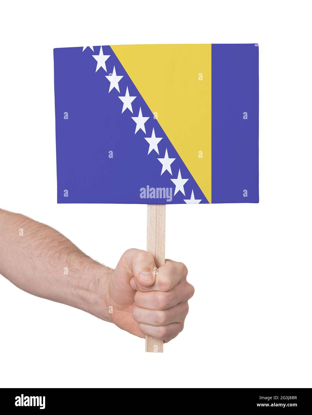 Hand mit kleiner Karte - Flagge von Bosnien-Herzegowina Stockfoto
