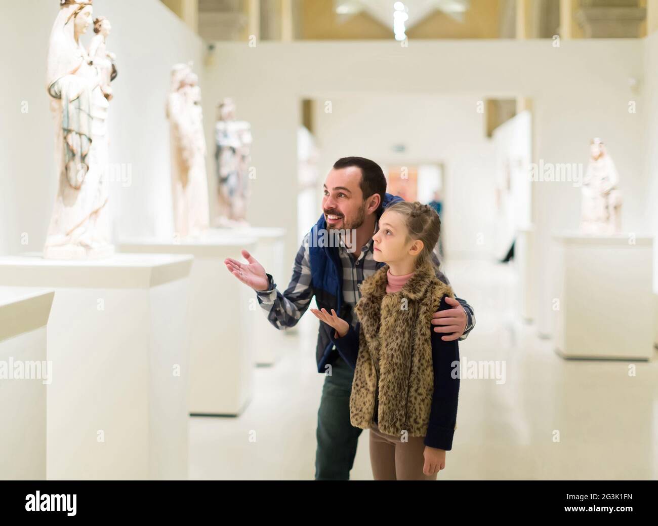 Vater und Tochter schauen sich alte Reliefs im Museum an Stockfoto