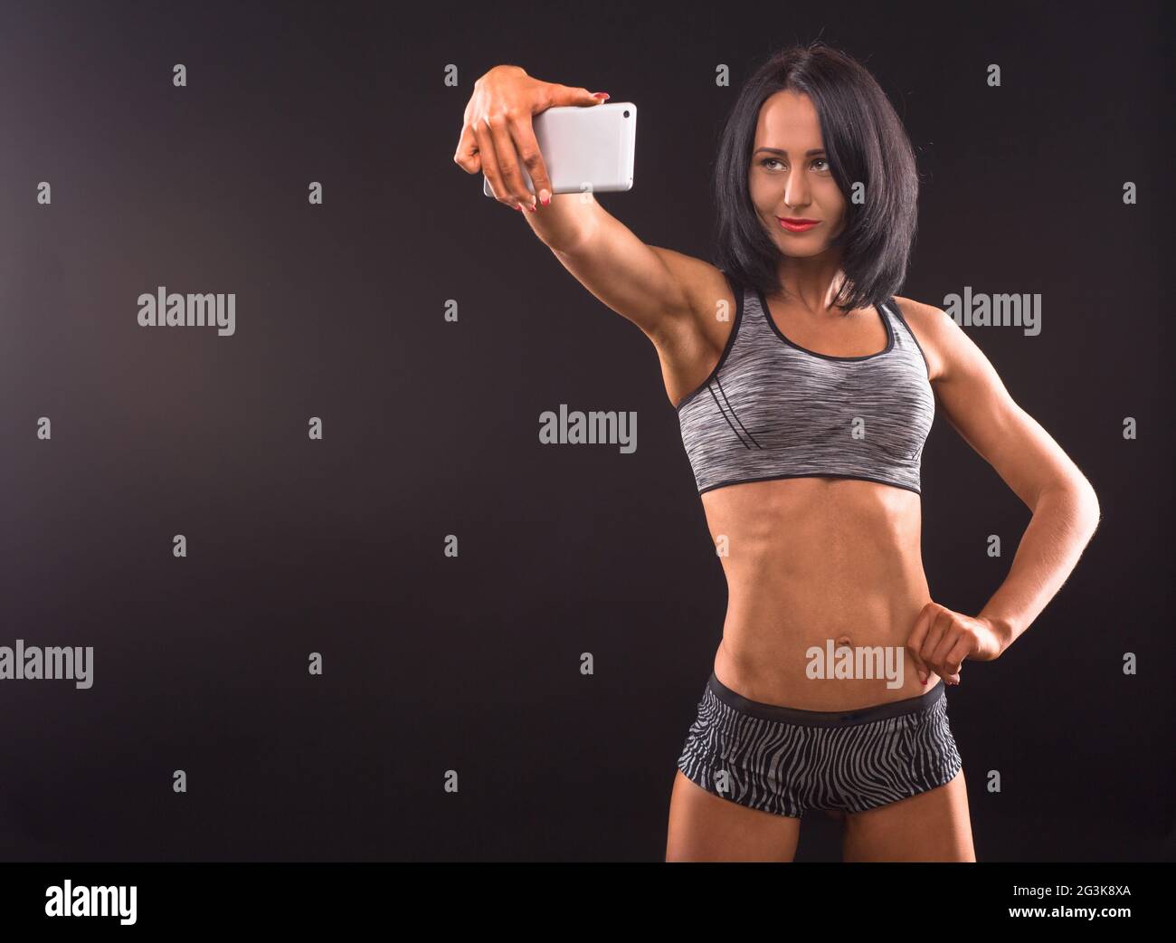 Fitness-Frau selbst fotografieren im studio Stockfoto
