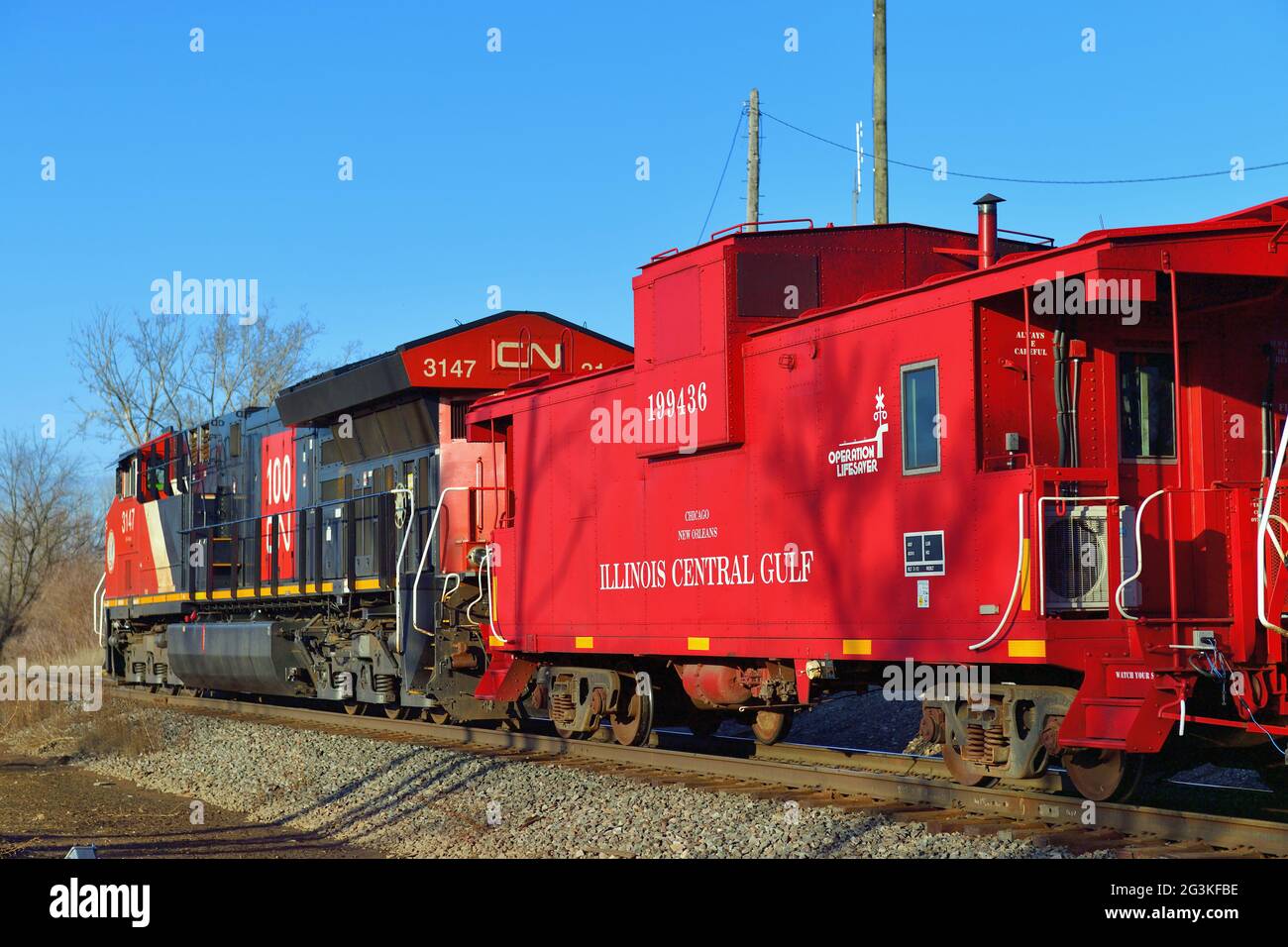 Bartlett, Illinois, USA. Ein Paar der Canadian National Railway Lokomotiven befestigt eine gut erhaltene Illinois Central Gulf Railroad-Kabinenbahn. Stockfoto