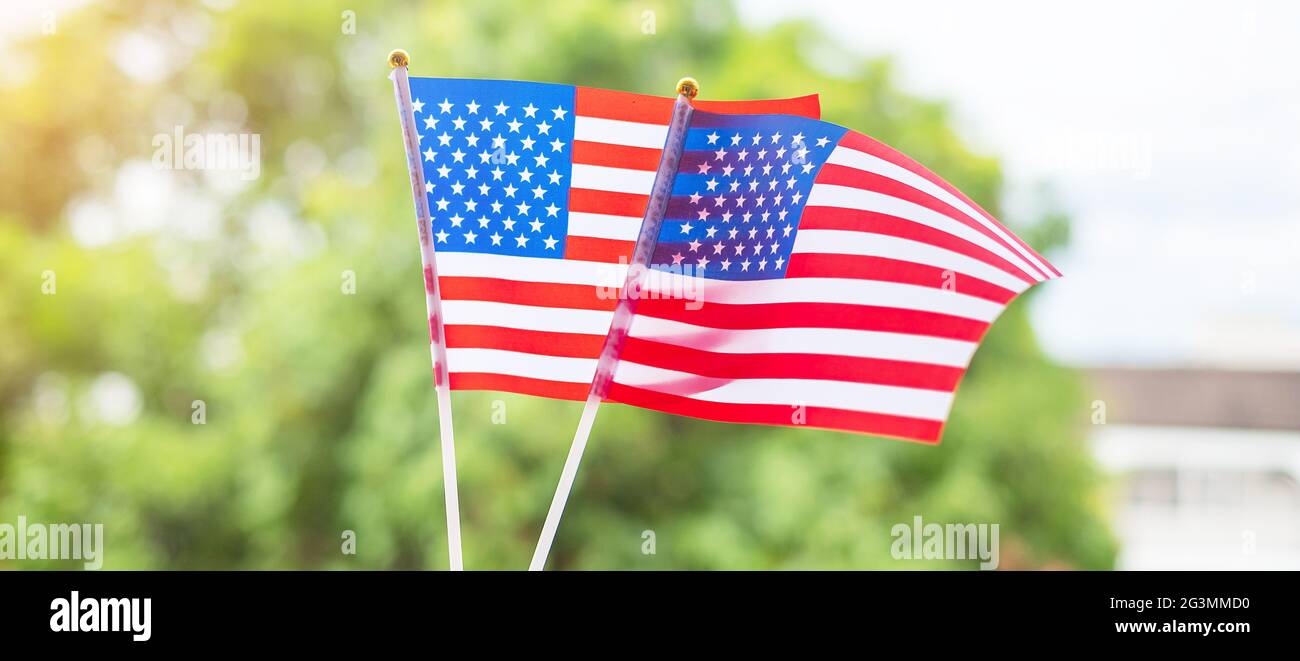 Hand hält die Flagge der Vereinigten Staaten von Amerika auf grünem Hintergrund. USA Feiertag der Veteranen, Memorial, Unabhängigkeit (4. Juli) und Labor Day concep Stockfoto