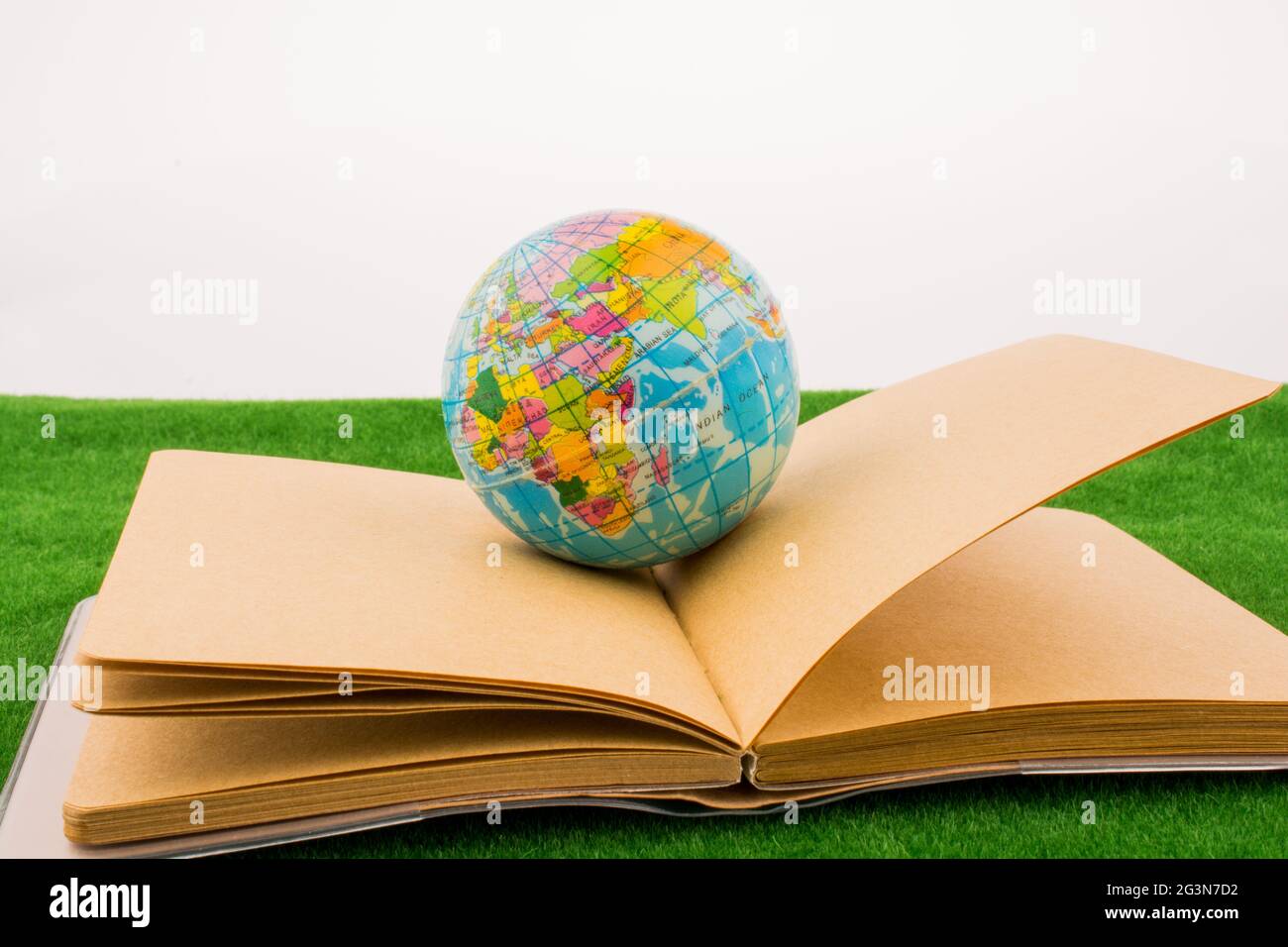 Globus in der Nähe eines Notebooks Stockfoto