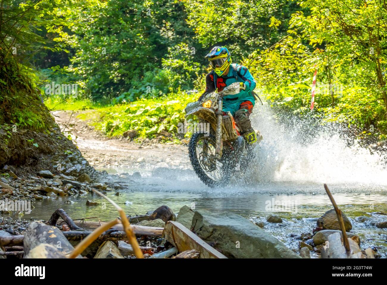 Enduro Racing im Sommer Sonnenwald und Spray Stockfoto