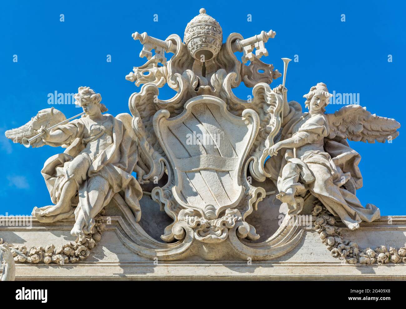 Das päpstliche Wappen von Clemens XII. Krönt die Fassade des Trevi-Brunnens in Rom Stockfoto