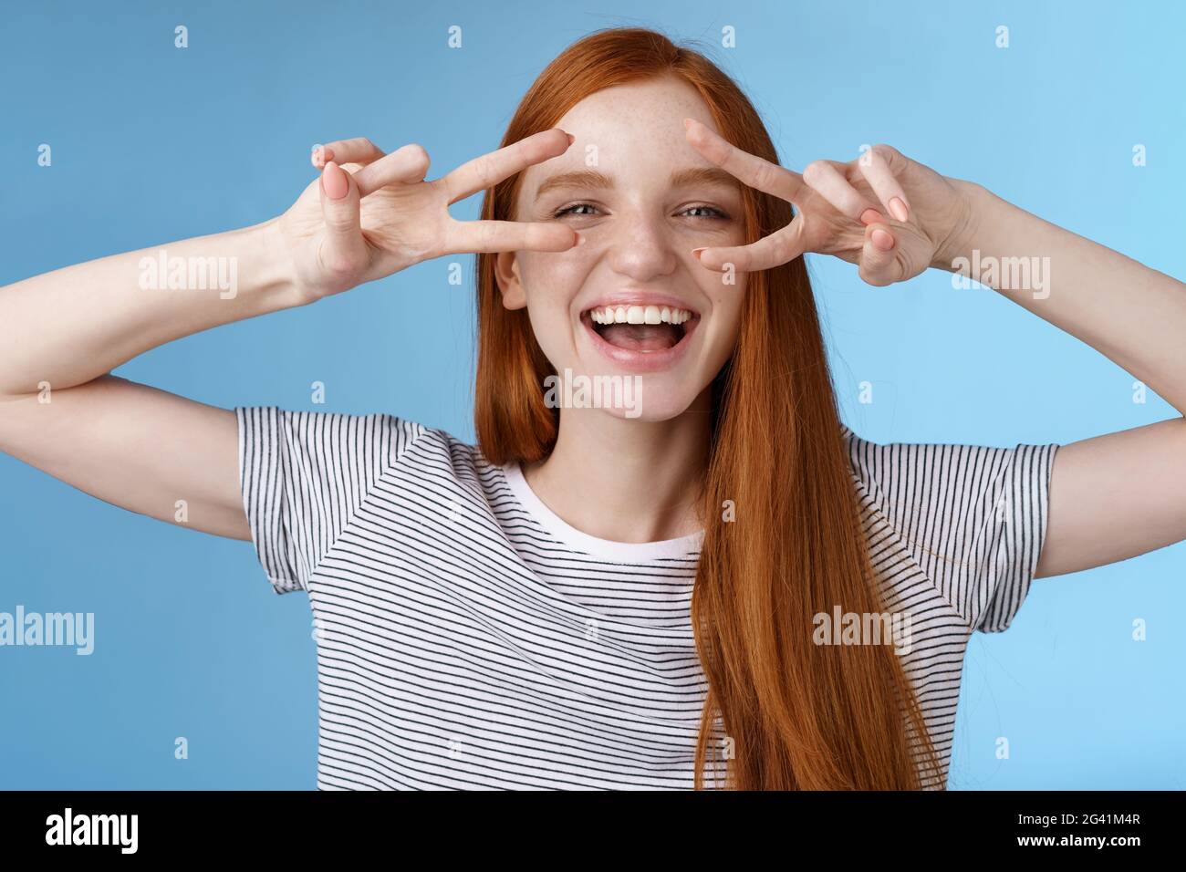 Glücklich fröhlich sorglos kaukasisch rothaarige Mädchen Ingwer lange Haare mit Spaß ausdrücken Glück Freude freundlich Haltung zeigen Frieden vi Stockfoto