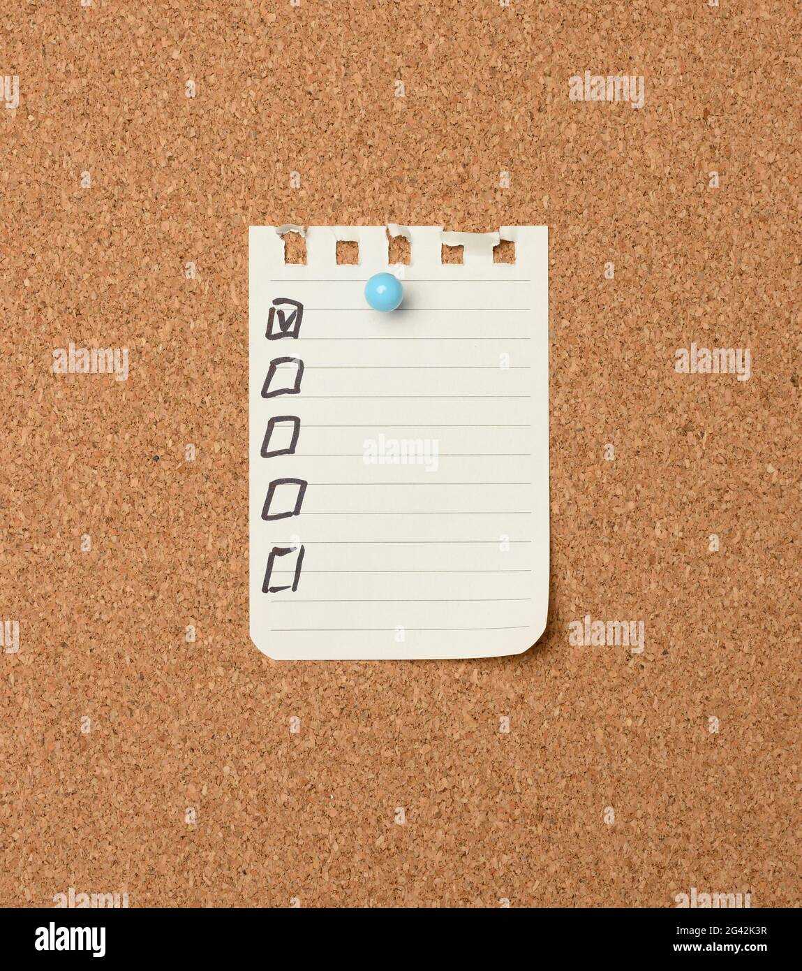 Leeres Blatt Papier in einer Linie, die mit einem Plastikknopf auf einem braunen Korkbrett befestigt ist Stockfoto