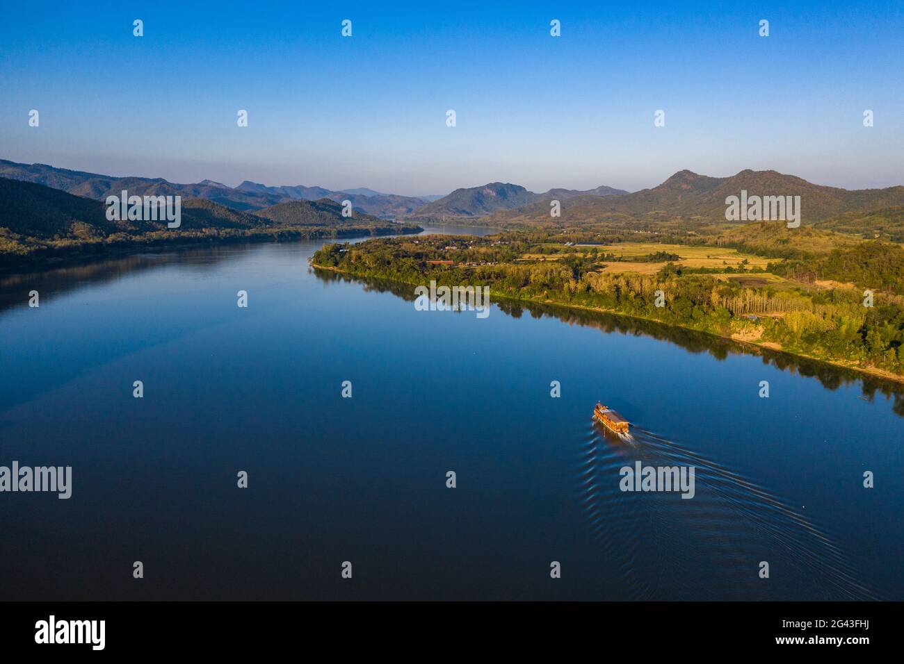Luftaufnahme des Flusskreuzfahrtschiffes Mekong Sun auf dem Mekong mit Bergen dahinter, Chomphet District, Luang Prabang Province, Laos, Asien Stockfoto