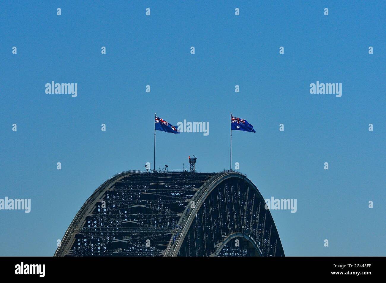 Die Harbour Bridge mit australischen Flaggen vor blauem Himmel, Sydney, New South Wales, Australien Stockfoto