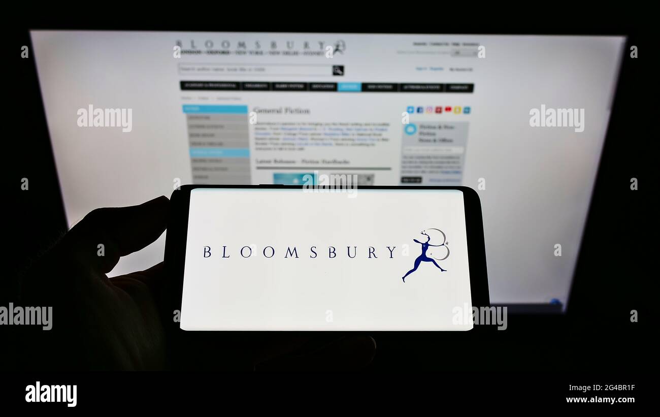 Person, die Mobiltelefon mit dem Logo des britischen Verlags Bloomsbury Publishing plc auf dem Bildschirm vor der Unternehmenswebsite hält. Konzentrieren Sie sich auf die Telefonanzeige. Stockfoto