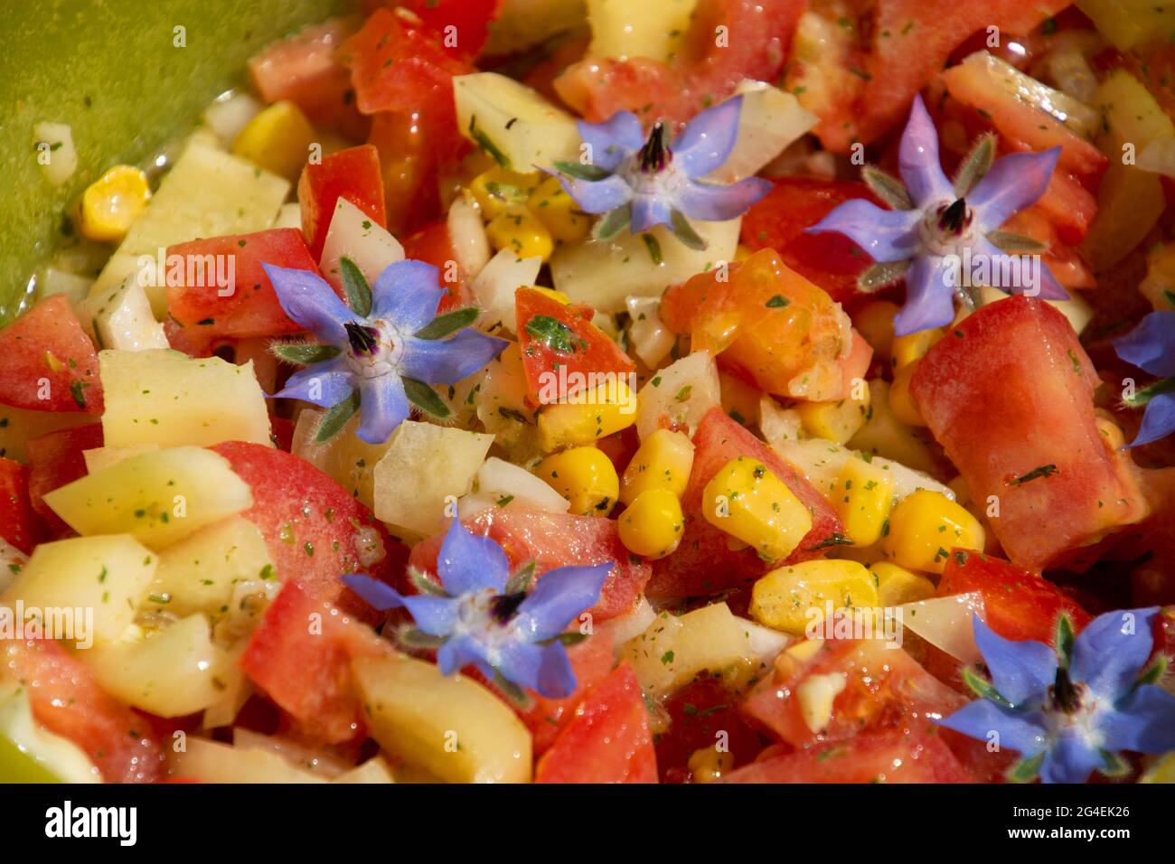 Salatmischung mit violetter Blumendekoration, zubereitet in einer Schüssel als vegetarisches Thema Stockfoto