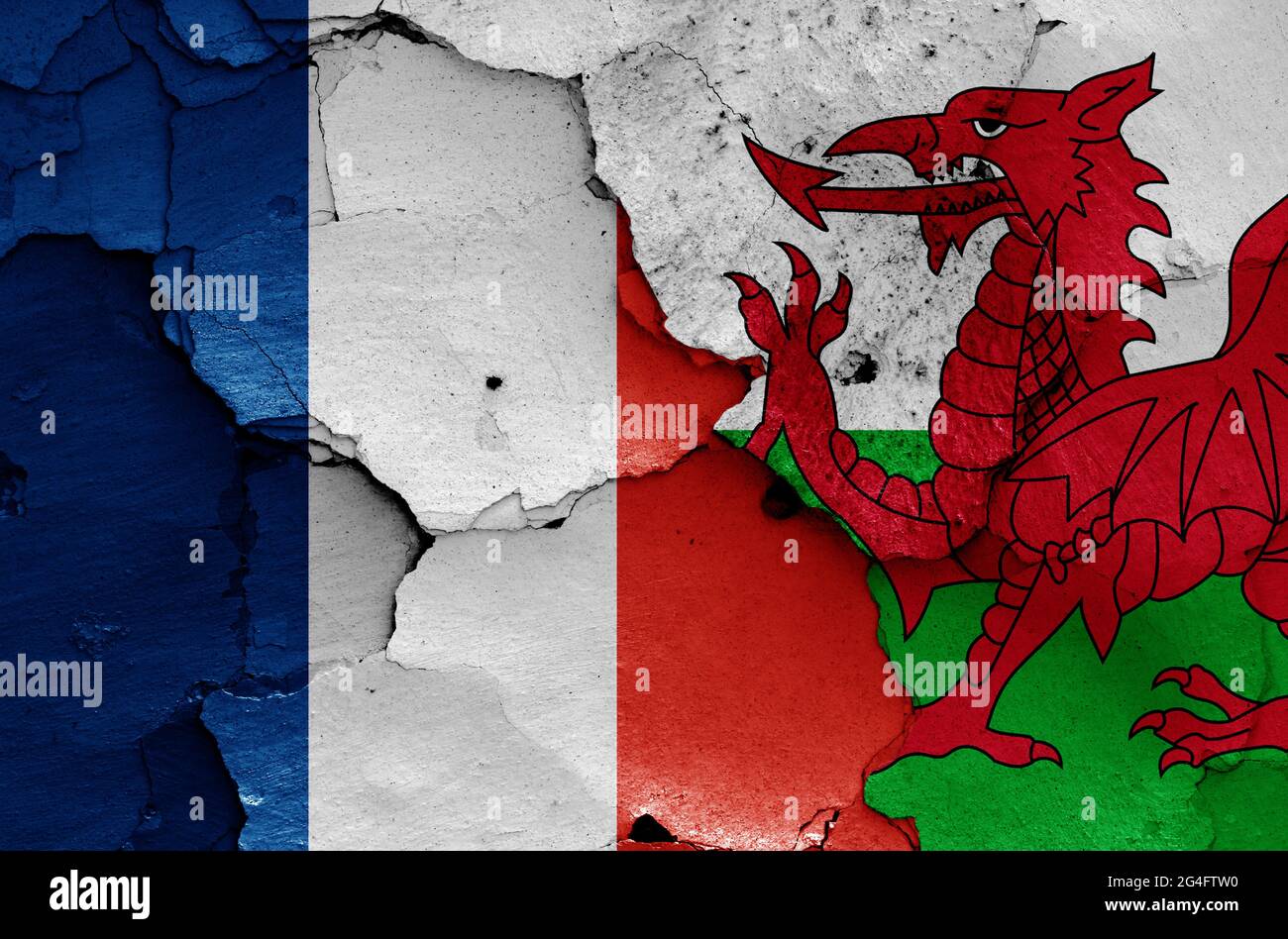 Flaggen von Frankreich und Wales auf rissige Wand gemalt Stockfoto
