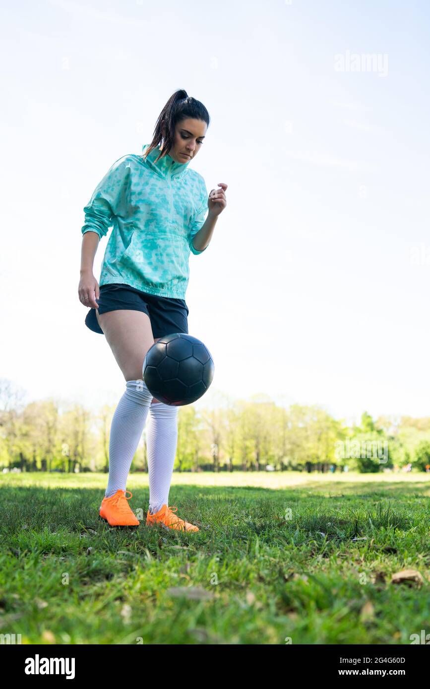 Junge Frau übt Fußball mit Ball. Stockfoto