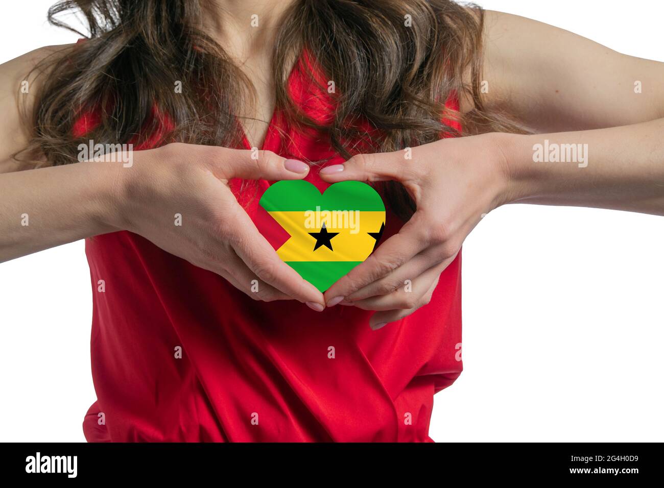 Ich liebe Sao Tome und Principe. Die Frau hält ein Herz in Form der Flagge von Sao Tome und Principe auf ihrer Brust. Konzept des Patriotismus. Stockfoto