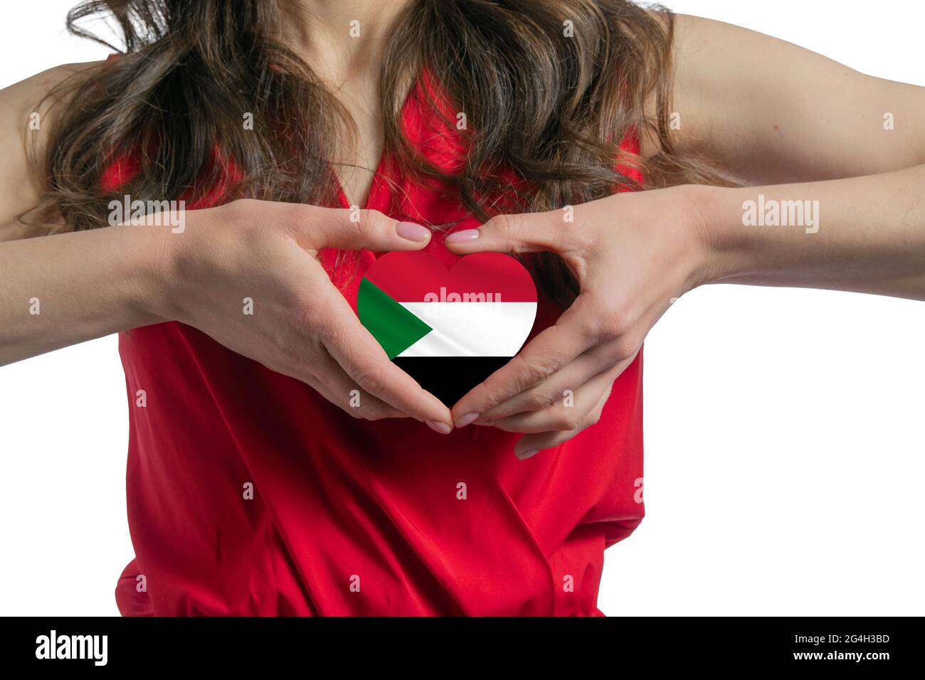 Ich Liebe Den Sudan. Die Frau hält ein Herz in Form der Flagge des Sudan auf ihrer Brust. Konzept des Patriotismus. Stockfoto