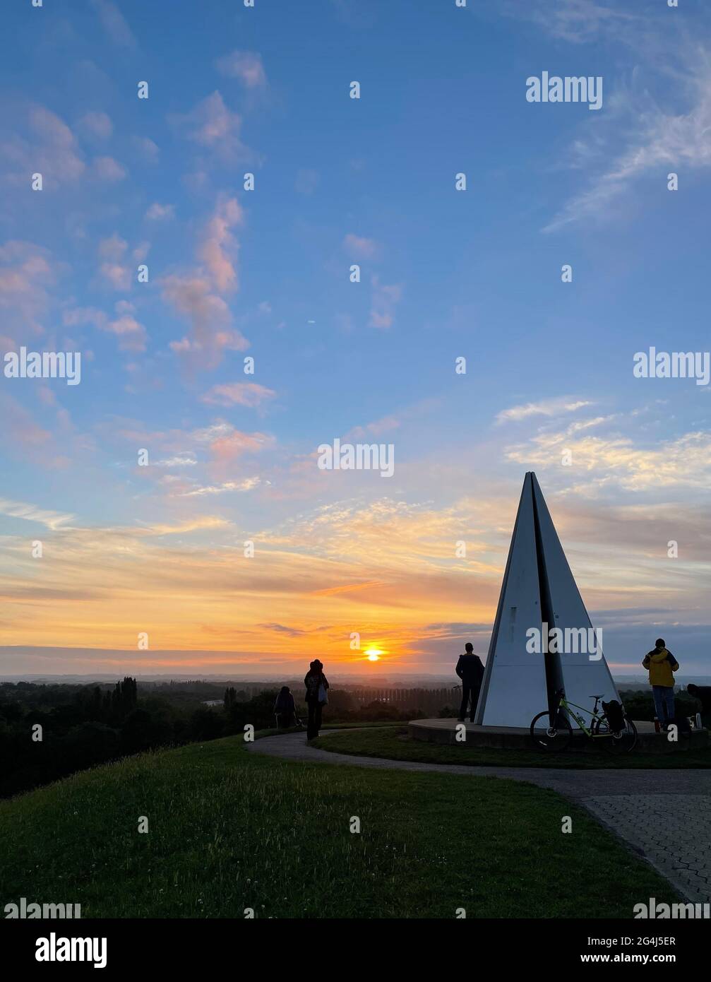 Der Sommersonnenwende-Sonnenaufgang an der Lichtpyramide im Campbell Park, Milton Keynes. Die Personen in diesem Bild sind nicht identifizierbar. Stockfoto
