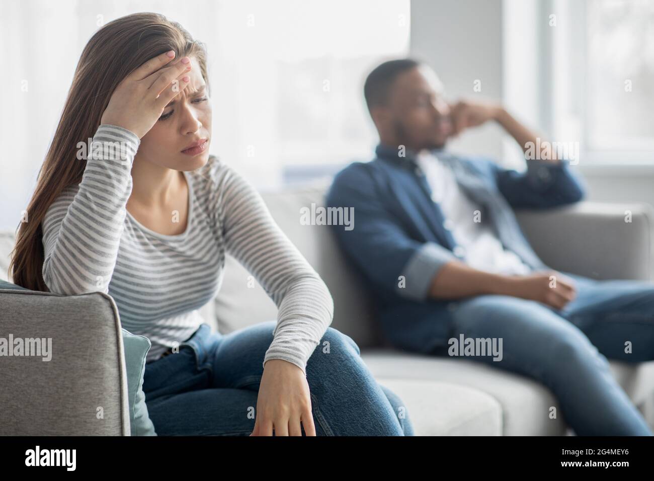 Verärgert Junge Interracial Ehegatten Sitzen Auf Der Couch, Ignorieren Einander Nach Streit Stockfoto