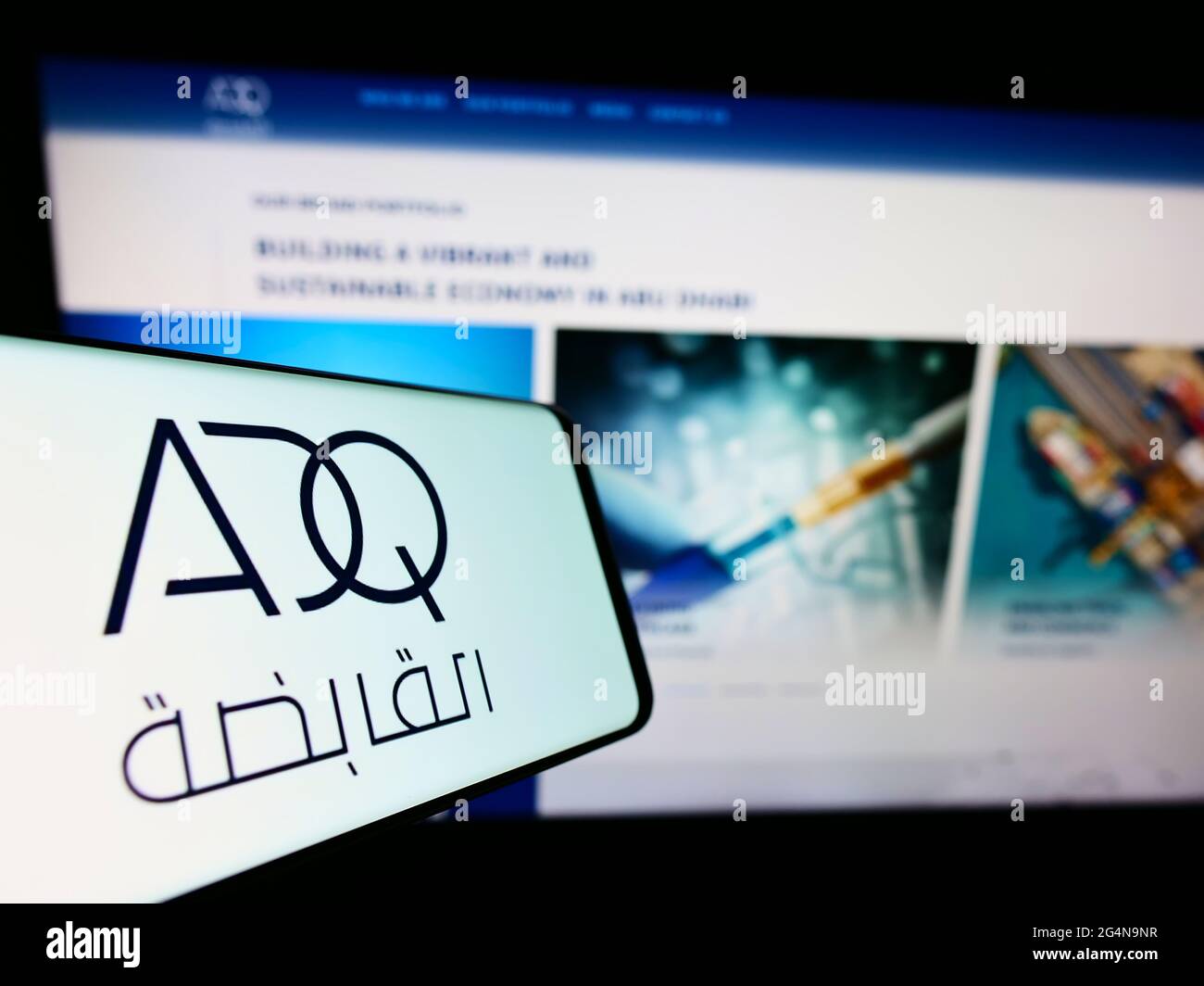 Smartphone mit Logo der Abu Dhabi Developmental Holding Company (ADQ) auf dem Bildschirm vor der Website. Konzentrieren Sie sich auf die Mitte rechts des Telefondisplays. Stockfoto