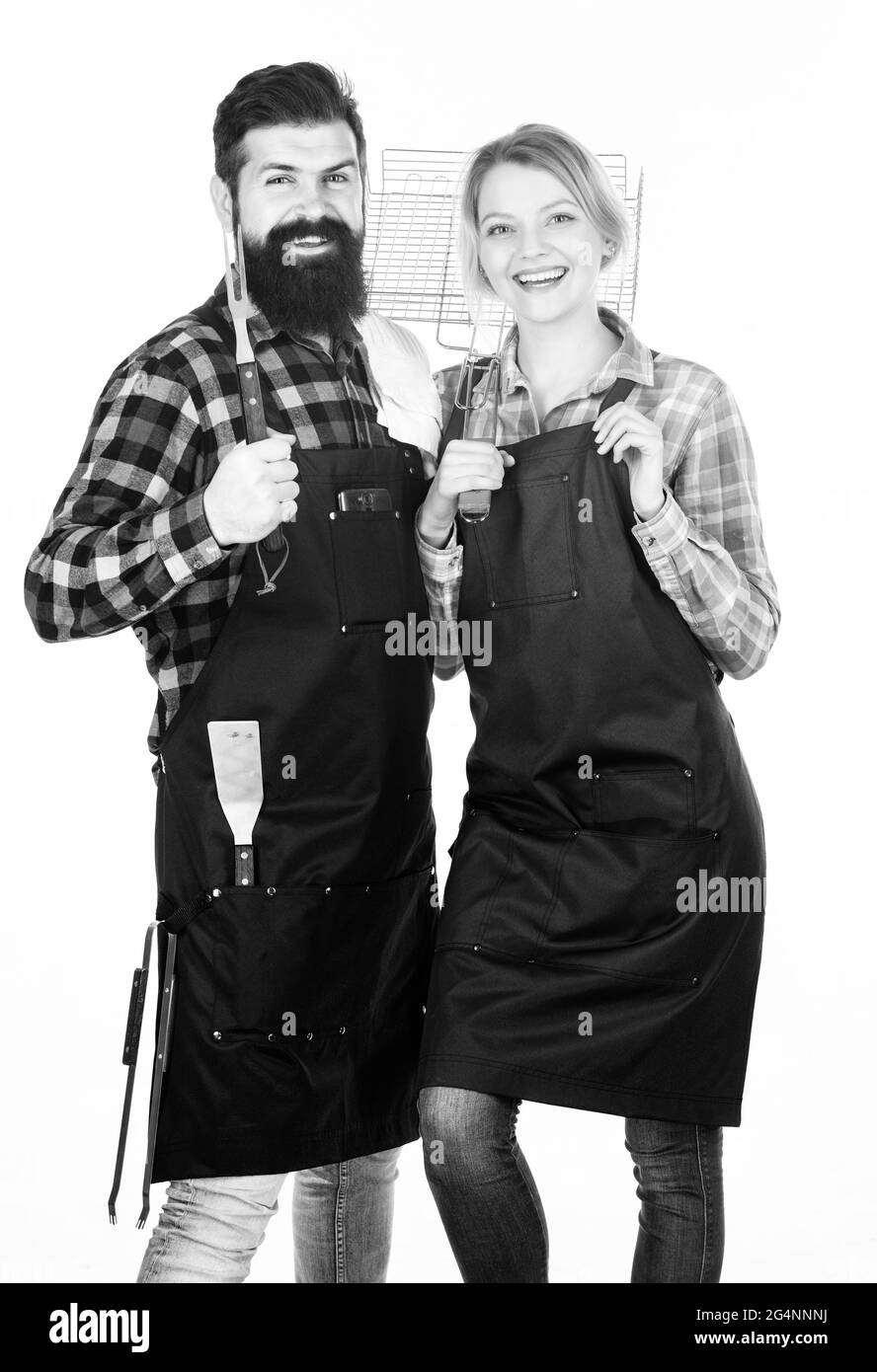 Werkzeuge zum Braten von Fleisch. Verliebte Paare halten Küchenutensilien bereit. Mann bärtige Hipster und Mädchen. Zubereitung und kulinarisch. Picknick-Grill. Essen kochen Stockfoto