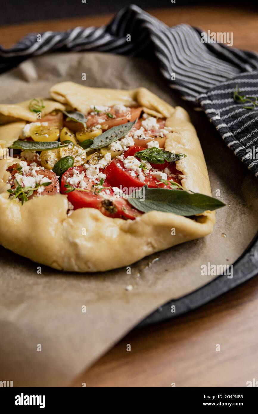 Tomate Galette mit hausgemachten Heirloom-Tomaten, Salbei und Feta-Käse, die gebacken werden sollen. Stockfoto