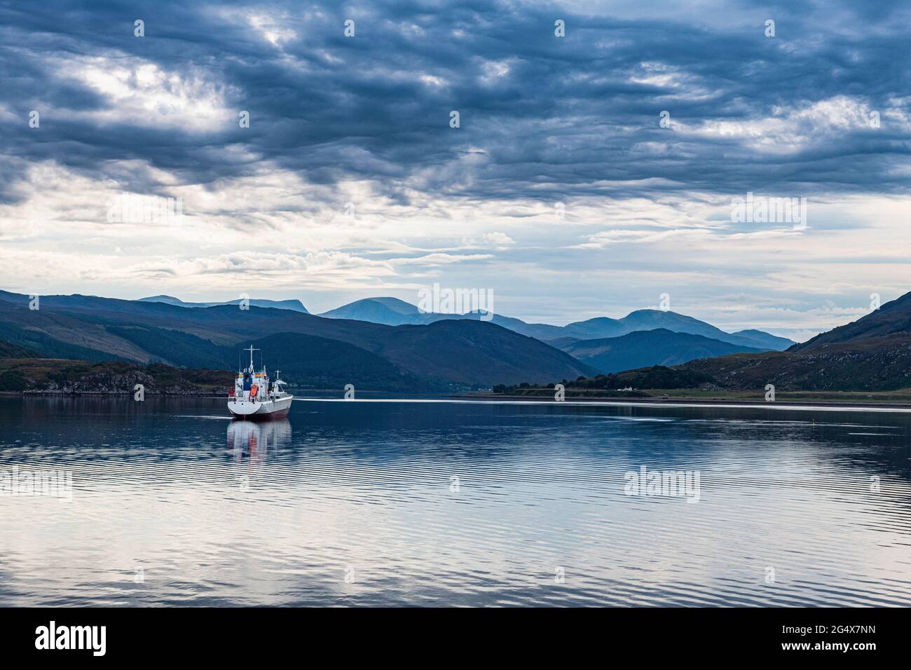 Großbritannien, Schottland, Ullapool, Wolken über einem einschifften Fischerboot, das über die Bucht in den schottischen Highlands segelt Stockfoto