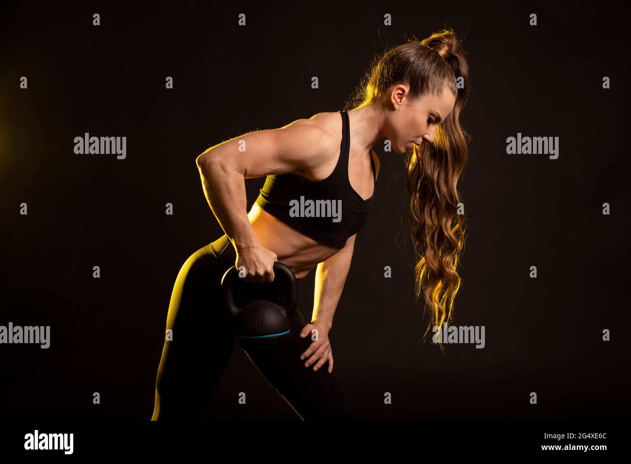 Sportlerin mit aktivem Ohr und Blick auf schwarzen Hintergrund Stockfoto