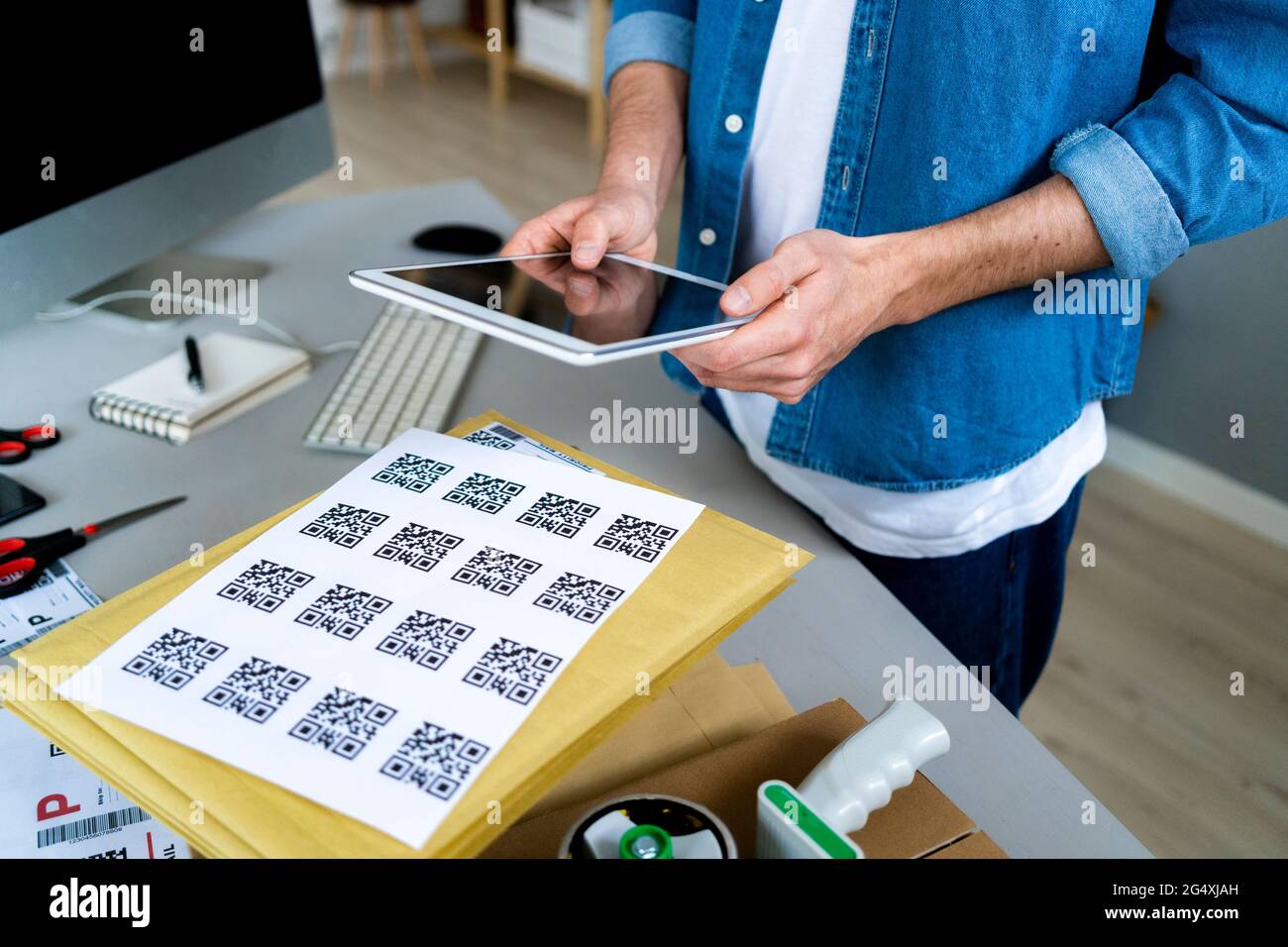 Geschäftsmann scannt QR-Codes im Büro Stockfoto