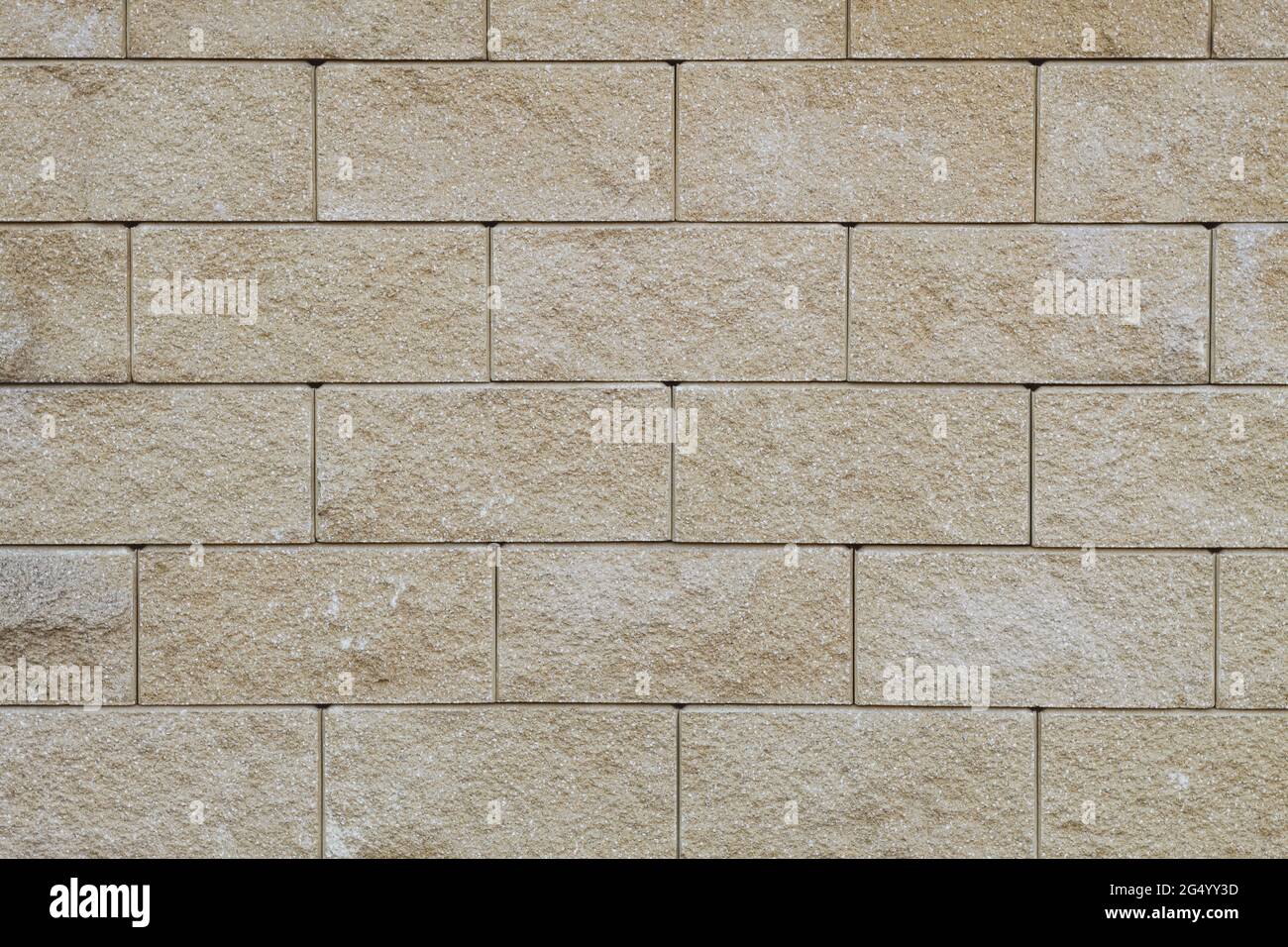 Textur einer Wand aus Betonsteinen aus der Nähe. Betonsteinmauer Stockfoto