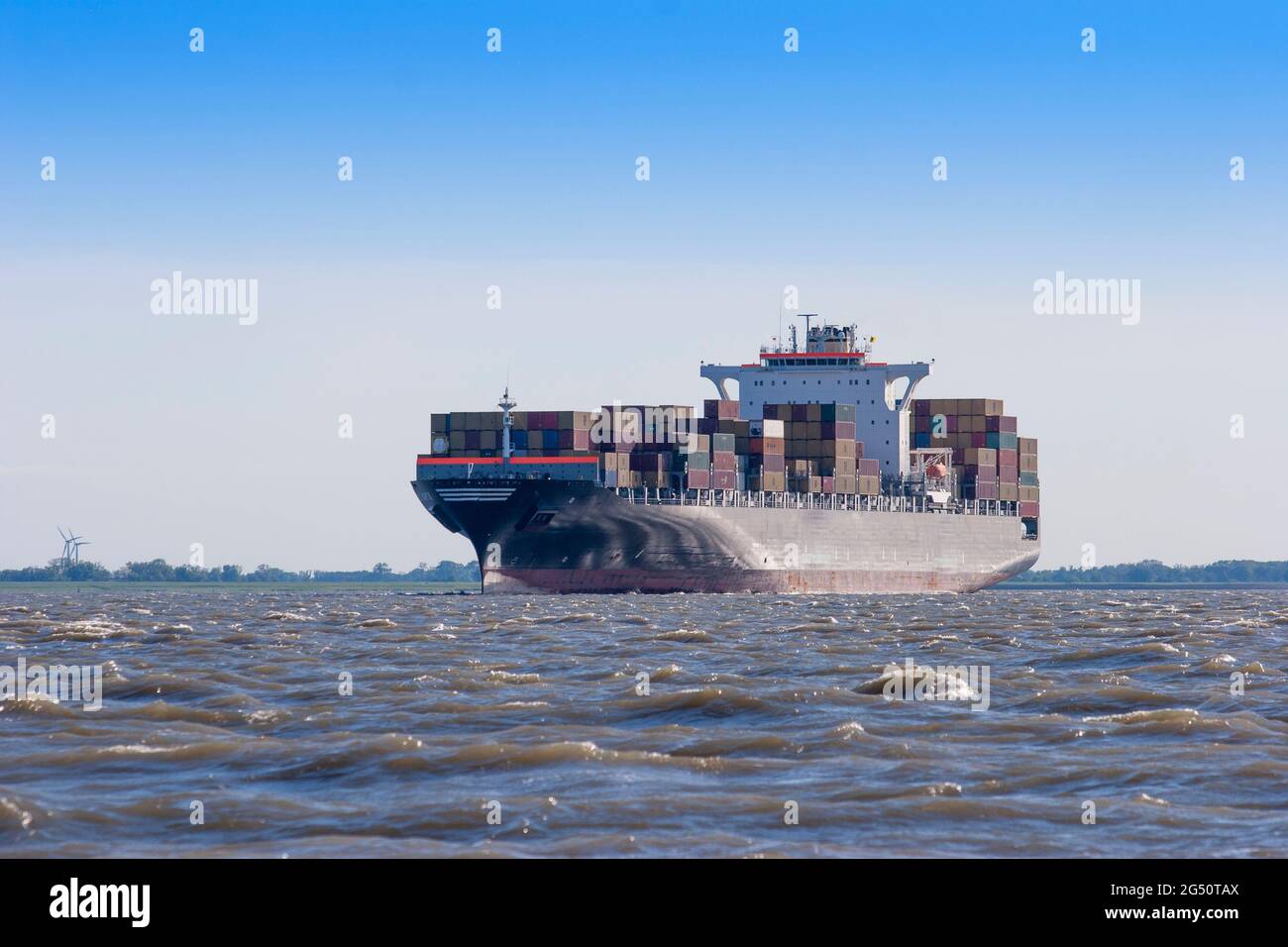 Riesiges Containerschiff, das bei ruhigem Wetter auf hoher See segelt Stockfoto